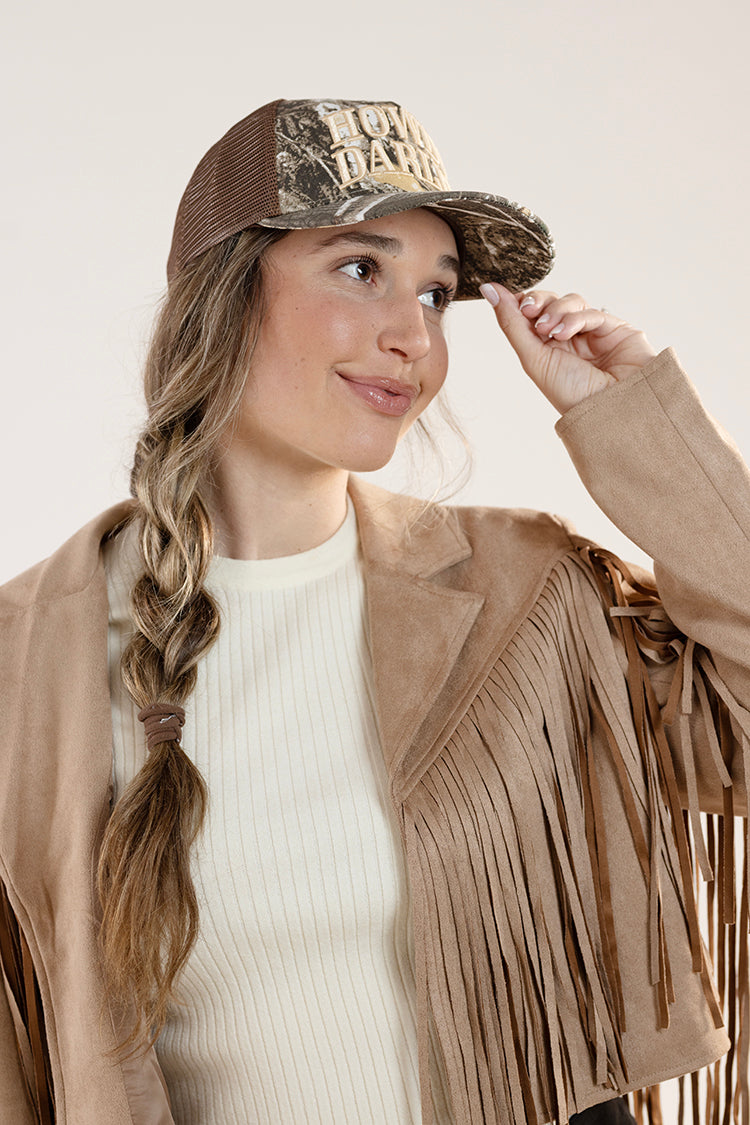 Woman wearing a Camouflage cap with 'Howdy Darlin'' text  white long-sleeve shirt with blue jeans -FleaStyle