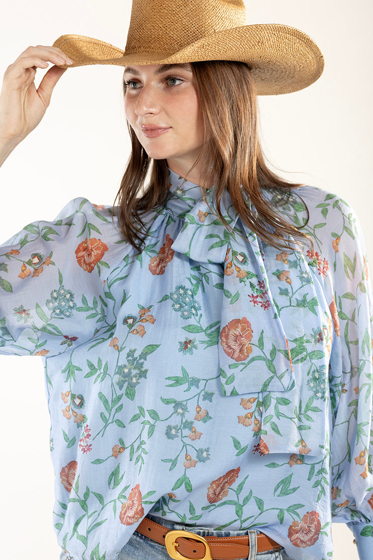 Woman wearing a floral blouse and Brooks Cowboy Straw Hat - Tan