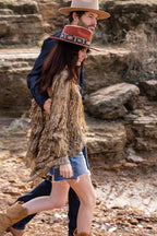 Two people walking together along the shoreline in a Lenny-Wool-Short-Brim-Hat-Rust