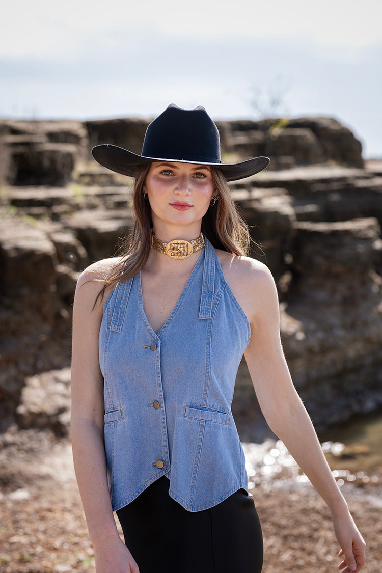 Woman wearing a blue vest andRider Wool Cowboy Hat - Black on a rocky shore-FleaStyle