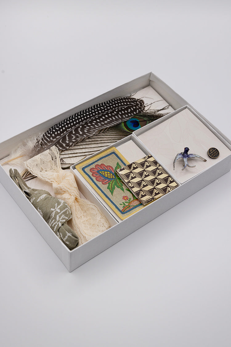 Collection of vintage items including feathers, cards, and a brooch- Bohemian Hat Styling Kit - Blue Hummingbird Brooch