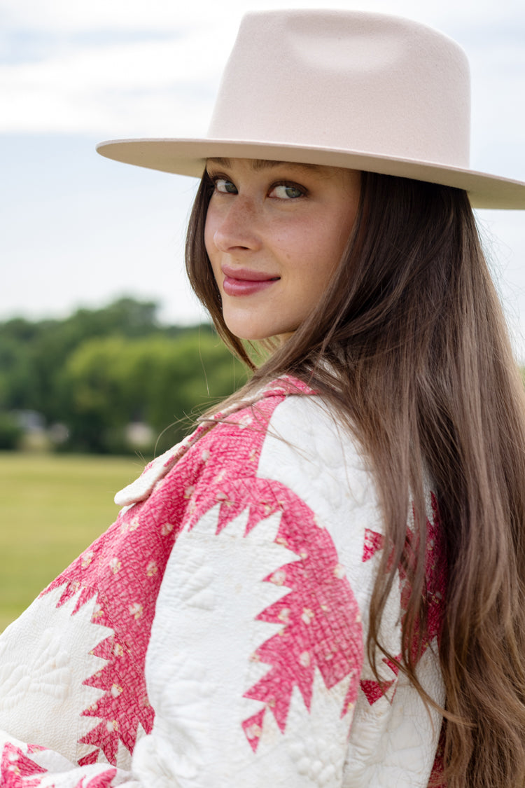 Woman sitting outdoors in a field wearing Lenny Wool Short-Brim Hat - Blush-Fleastyle