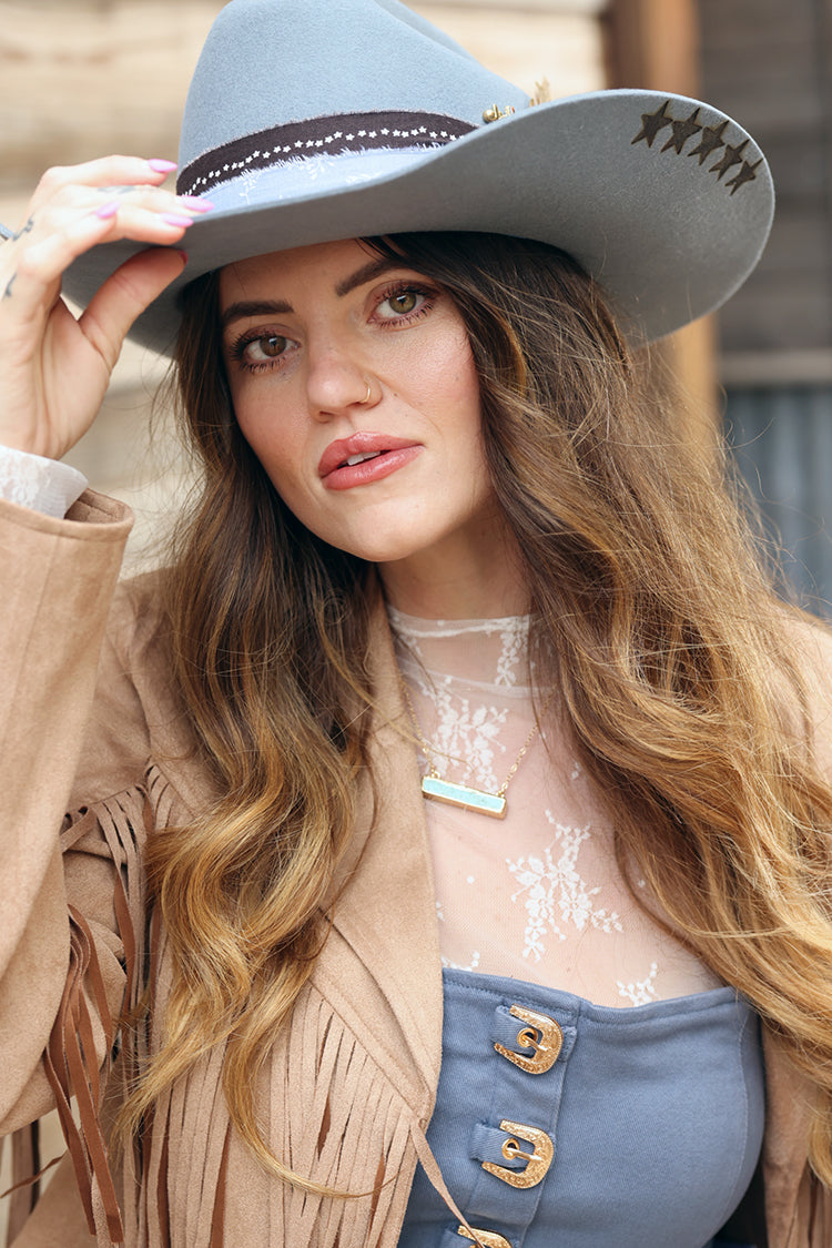 Woman wearing a branded Dusty Blue Hat branded custom cowboy hat with decorative feathers, custom hat bands, vintage brooches and hat pins-FleaStyle