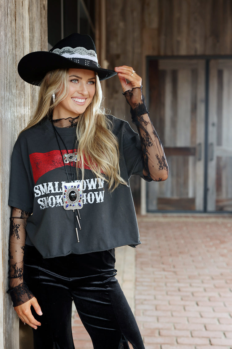 Woman wearing a One-of-a-Kind-Custom-Cowboy-Hat-Black with decorative feathers, custom hat bands, vintage brooches and pearl hat pins-FleaStyle