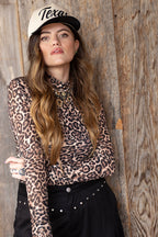 Woman wearing a leopard print mesh top and black  'Texas' embroidered trucker hat-FleaStyle