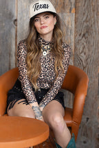 Woman wearing a leopard mesh print top and 'Texas' embroidered trucker cap-FleaStyle